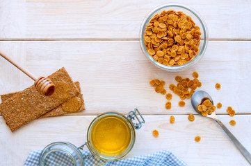 flakes for breakfast with honey on wooden bacgkround top view