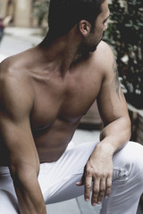 Fototapeta na wymiar Handsome muscled topless man outdoor portrait