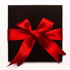 Black paper card with red textile ribbon isolated on white
