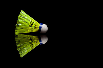 Yellow plastic shuttlecocks with blue strip isolated on black re