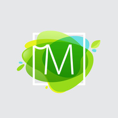 M letter logo in square frame at green watercolor splash backgro