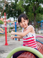 Fototapeta na wymiar Happy asian baby child playing on playground