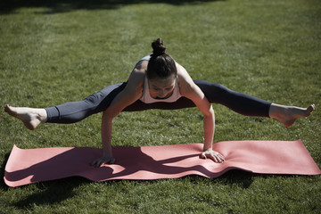 Peacock pose, asana yoga on wrists in park
