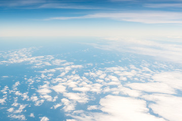 Cloudscape skyline view above white clouds and blue sky