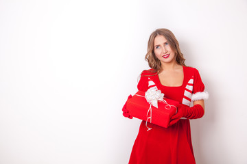 Fototapeta premium Beautiful girl wearing santa claus clothes with christmas gift