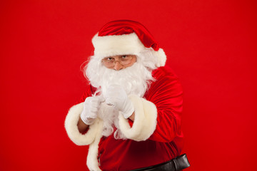 Santa Claus is preparing for fight. red background.