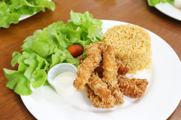 fried rice and breaded fried chicken in white plate