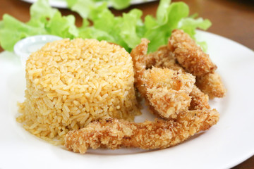 fried rice and breaded fried chicken in white plate
