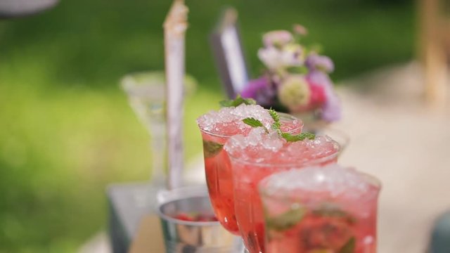 Final stage of preparing cocktail strawberry mojito for banquet.