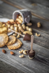 chocolate and nuts on wooden background