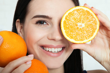 Woman with orange close-up face. Beautiful women exists to clean skin on the face. Asian woman.