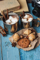 Metal mugs with cacao and marshmallows