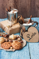 Metal mugs with cacao and marshmallows