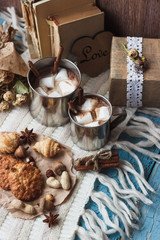 Metal mugs with cacao and marshmallows