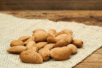 Almonds on a burlap background.