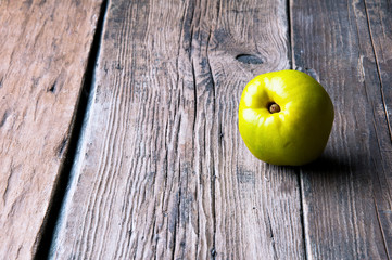 Green apple on wooden background. Copyspace