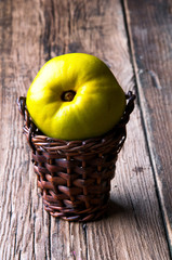 Green apple in small wicker basket