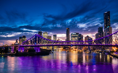Fototapeta na wymiar Vibrant night time panorama of Brisbane city with purple lights