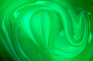 Mixed green oil paint abstract background, close up view.