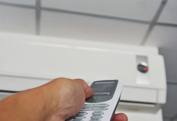 hand open air conditioner on wall by remote control