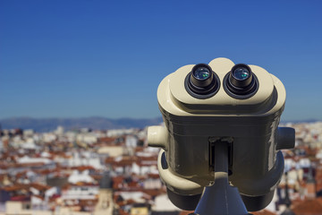 Binoculars placed on the roof of a building in a city