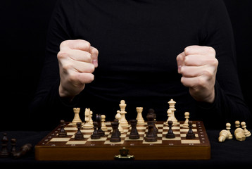 closeup of a wooden chess board with chess figures and the girl'