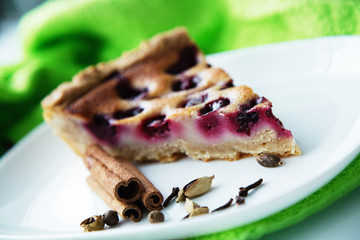 Slice of cherry pie on a white plate