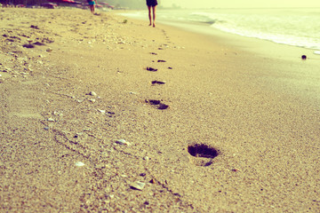 Footprints in the sand at sunset
