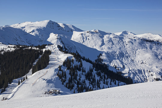 Ski slope in the sunny day on the background of the Ausrtian Alp