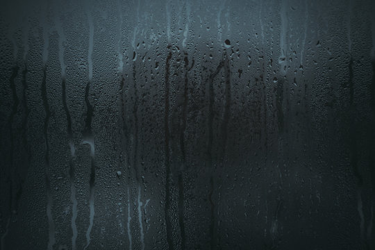 Flowing Down Water Drops On Glass