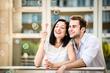 Couple have fun with bubble blower