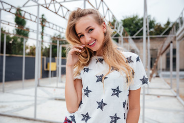 Fototapeta premium Smiling young woman standing outdoors