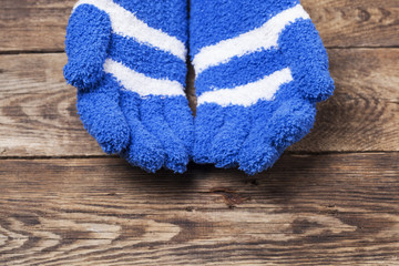 Winter gloves on wooden background