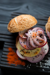 Close-up of a burger with spanish traditional pulpo a la gallega