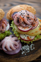 Burger with galician style octopus, close-up, selective focus