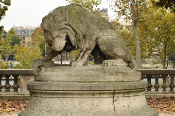 Lion sculpture fighting with a snake in a French park