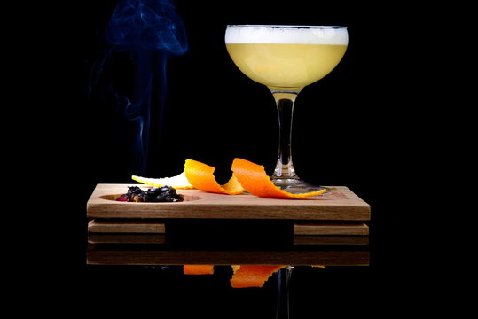 Alcoholic Drinks With Orange Peel And Smoke On Black Background