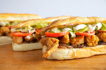 Three sub hoagie sandwiches closeup