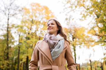 beautiful happy young woman walking in autumn park