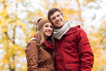 happy young couple walking in autumn park