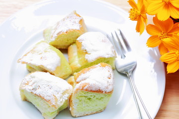 Sweet butter bread of dish on the wooden table and flower.