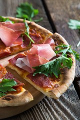 Pizza with prosciutto and arugula