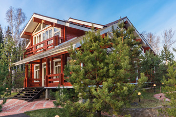 Wooden cottage of red painted logs