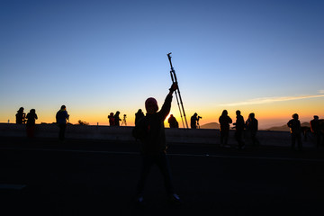 Photographers take a photo on the hill with tripod at Inthanon mountain, Chiang mai, Thailand