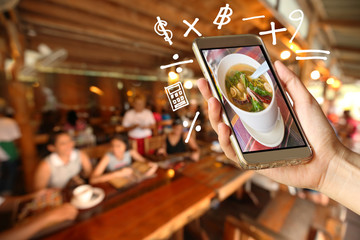 Woman Hand holding smartphone with Geometry symbol in the restaurant for order some food