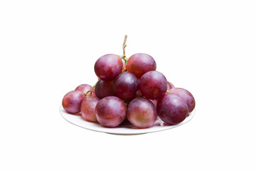 Ripe red grapes in white plate isolated on white background.