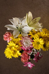 Mixed flowers with pink, yellow, and white colors.