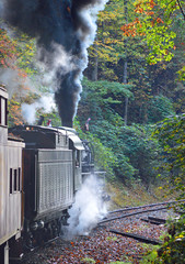 Vintage steam train in the autumn mountains