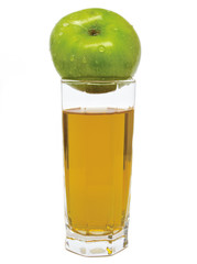 Glass of apple juice with green apple on top