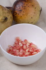 Pomegranate  and seeds closeup in a white background.